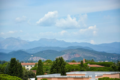 Houses on mountain against sky