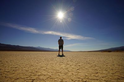 Man standing on desert against sky