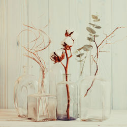 Close-up of white vase on table against wall at home