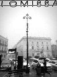 Cars on street against buildings in city