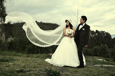 Portrait of young couple standing outdoors