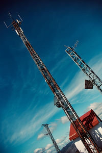 Low angle view of crane against sky