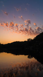 Scenic view of lake against romantic sky at sunset