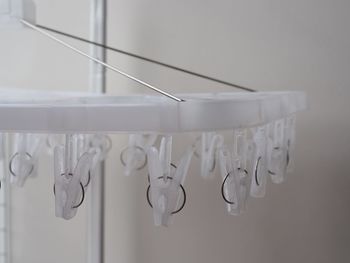 Close-up of clothes hanging on white wall