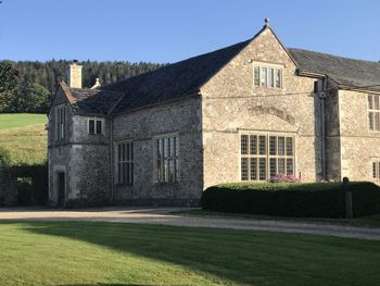 Building against clear sky with lawn in foreground