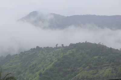 Scenic view of mountains against sky during foggy weather