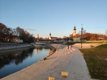 River amidst buildings against clear sky