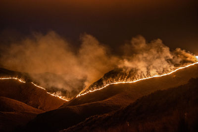 Panoramic view of volcanic mountains against sky at night