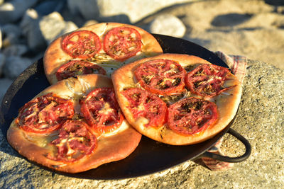 Individual tomato focaccia breads on flat metal pan