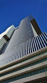 Low angle view of modern building against clear blue sky