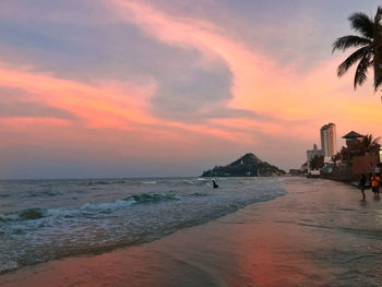 Scenic view of beach against sky during sunset