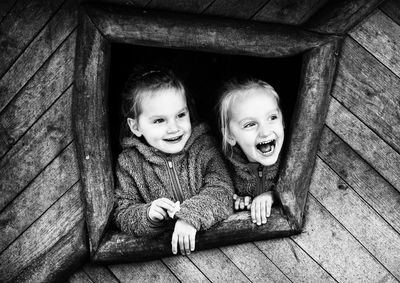 Happy sisters in tree house