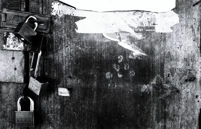 Close-up of padlocks on brick wall