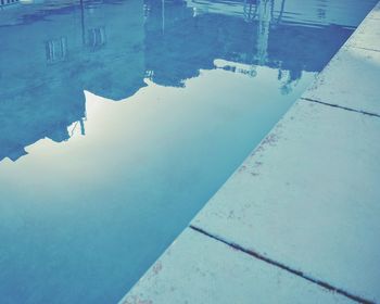 Reflection of building in puddle