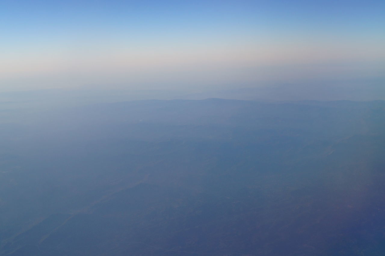 AERIAL VIEW OF MOUNTAINS AGAINST SKY