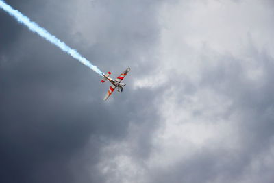 Low angle view of airplane flying in sky