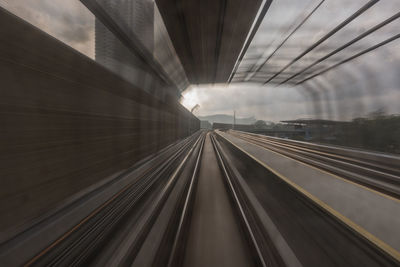 Blurred motion of railroad track in tunnel during sunset