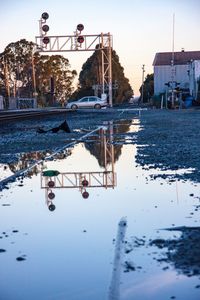 Reflection of trees in water against clear sky
