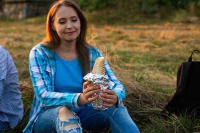 Portrait of a smiling girl sitting on land