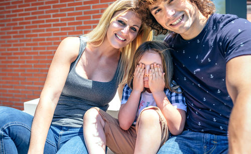 Portrait of a smiling young woman sitting outdoors