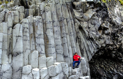 Rear view of woman standing on rock