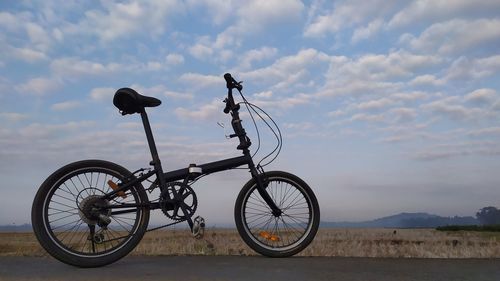 Side view of bicycle parked on field