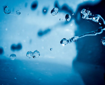 Close-up of bubbles against blue water