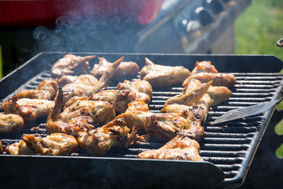 High angle view of chickens roasting on barbecue