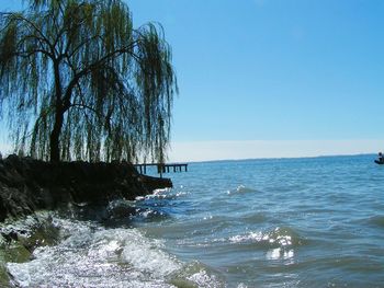 Scenic view of sea against clear blue sky