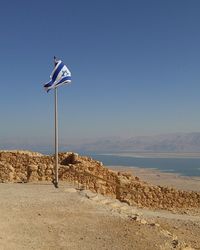 Scenic view of beach against blue sky