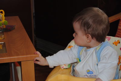 Full length of cute girl holding table