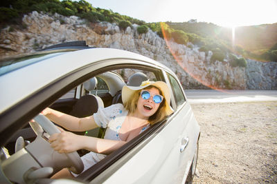 Side view of woman in car