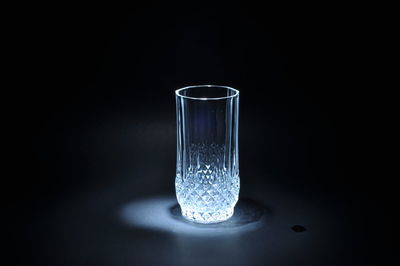 Close-up of water glass against black background
