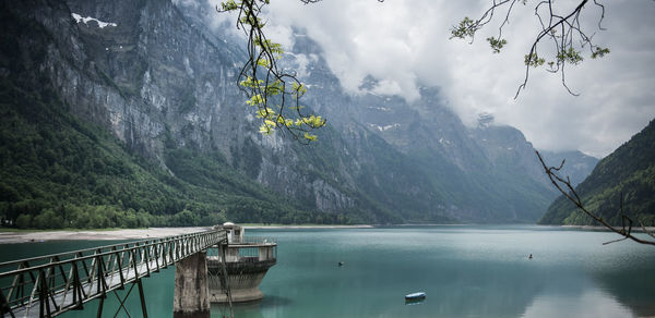 Scenic view of lake and mountains against sky