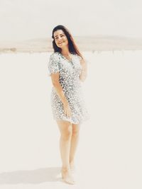 Portrait of woman standing on beach