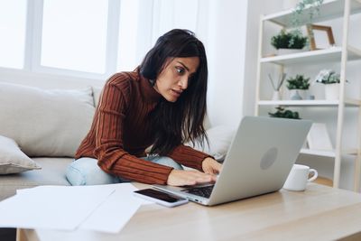 Young woman using laptop at home