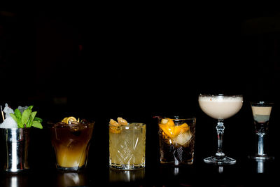 Close-up of wine glasses against black background