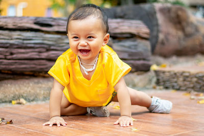 Portrait of the cute boy sitting on the floor