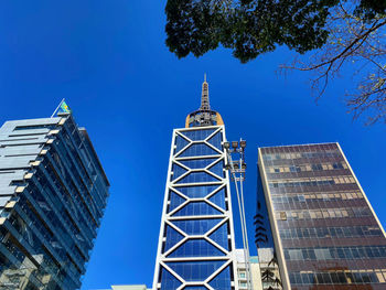 Low angle view of modern building against blue sky