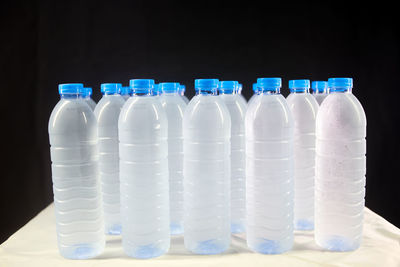 Close-up of white bottles against blue background