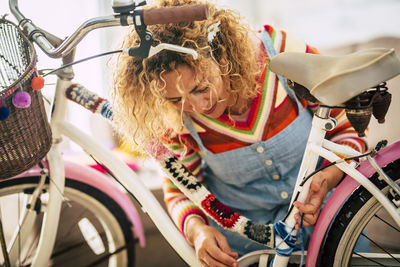 Smiling woman with bicycle outdoors