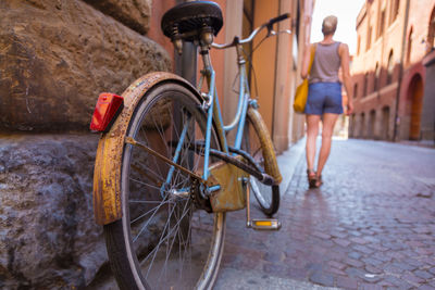 Rear view of woman with bicycle on street