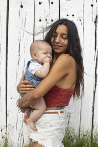 Mother and baby girl standing on outdoors