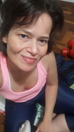 Portrait of a smiling girl sitting at home