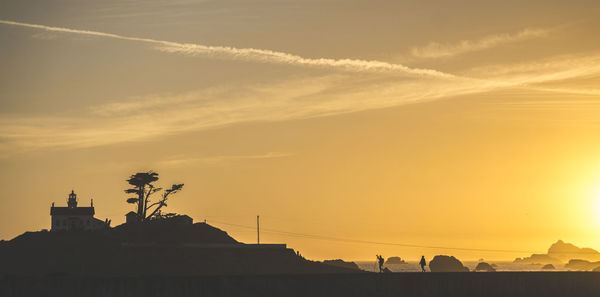 Low angle view of silhouette buildings against sky during sunset