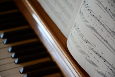 Close-up of sheet music on piano 