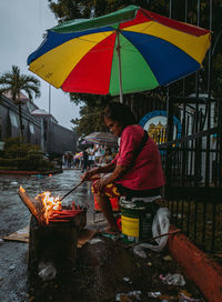 Man with umbrella standing in rain