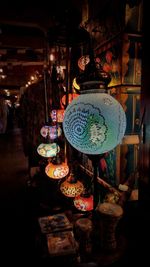 Illuminated lanterns hanging at store