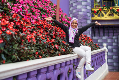 Rear view of woman against purple flowering plants