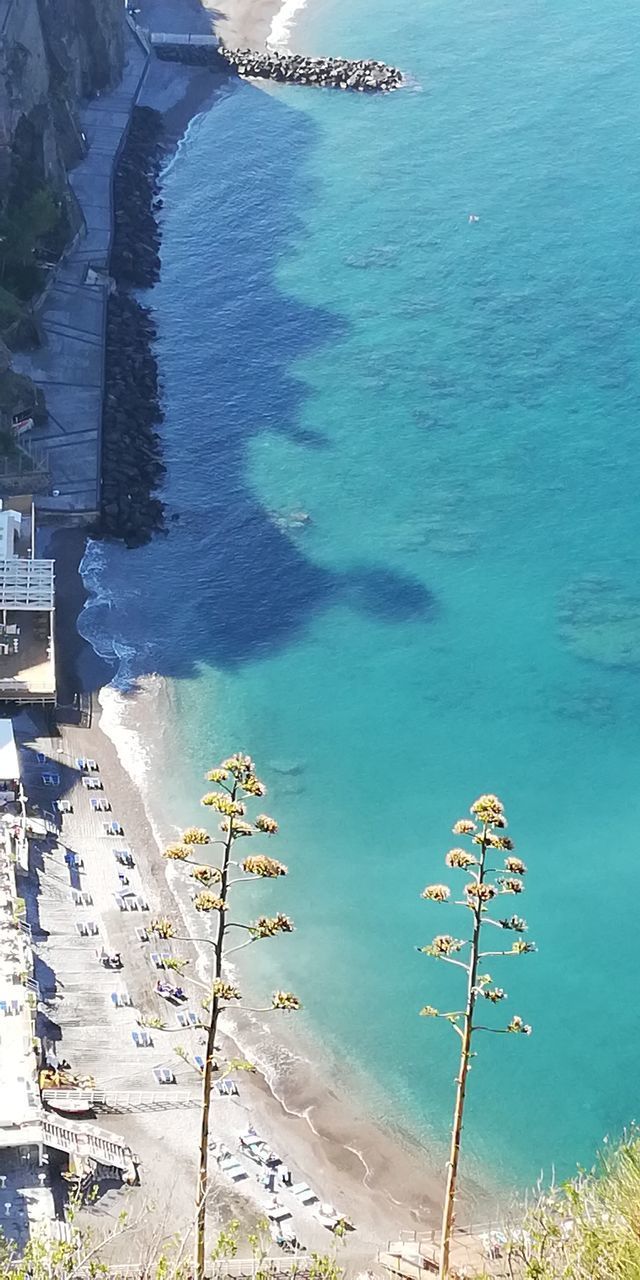 HIGH ANGLE VIEW OF SWIMMING POOL BY SEA AGAINST CITY